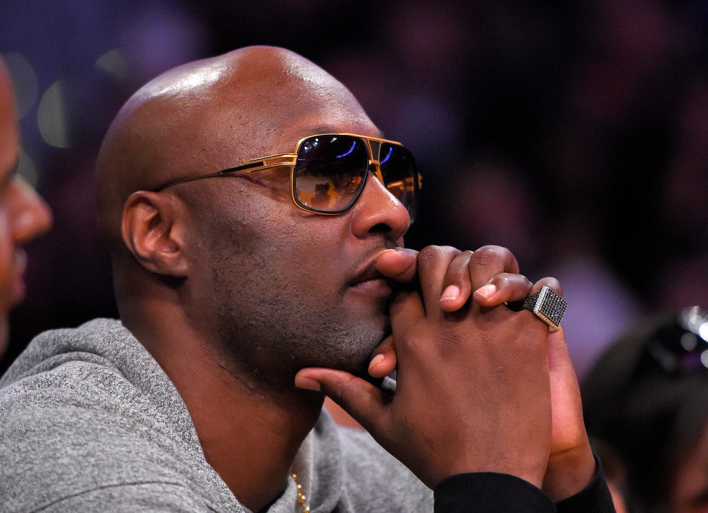 FILE - Former Los Angeles Lakers' player Lamar Odom watches during the second half of an NBA basketball game between the Lakers and the Miami Heat in Los Angeles, March 30, 2016. (AP Photo/Mark J. Terrill, File)