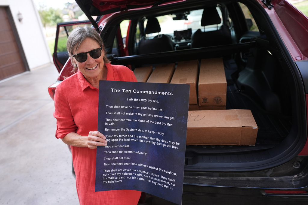 Debbie Leimbach displays one of the hundreds of Ten Commandments posters she was preparing to deliver to local public schools in New Braunfels, Texas, Monday, Nov. 17, 2025. (AP Photo/Eric Gay)