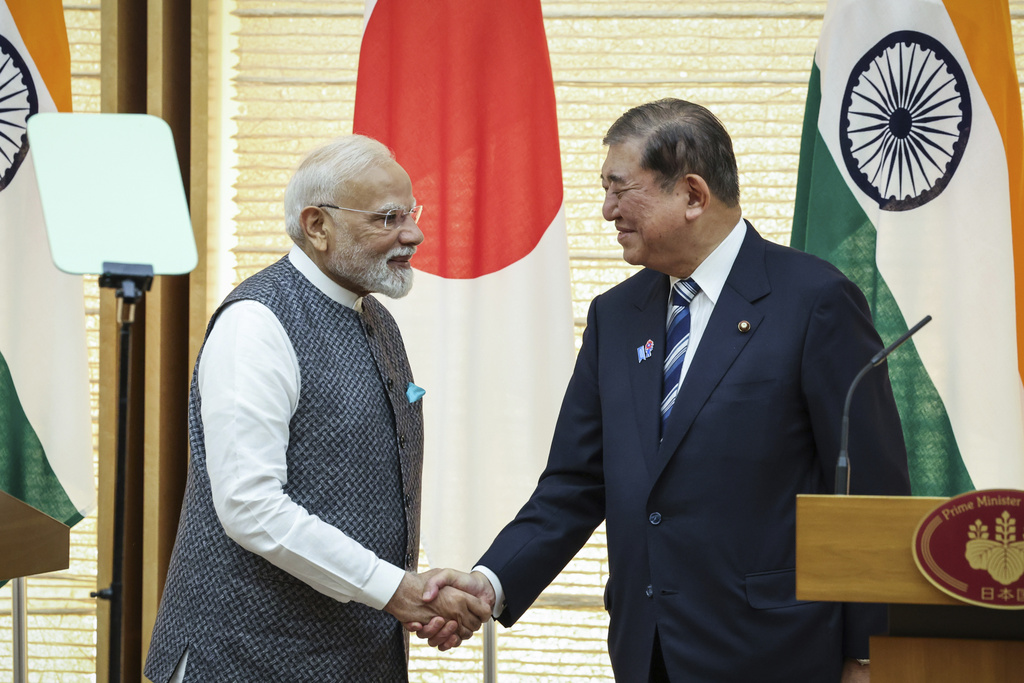 India's Prime Minister Narendra Modi, left, and Japan's Prime Minister Shigeru Ishiba shake hands during a joint press conference in Tokyo, Japan, Aug. 29, 2025. (Takashi Aoyama/Pool Photo via AP)