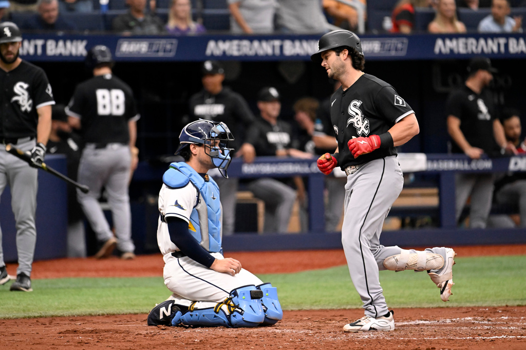Tampa Bay Rays catcher Nick Fortes, center left, waits as Chicago White Sox's Andrew Benintendi, right, crosses the plate after hitting a home run during the fourth inning of a baseball game Sunday, Aug. 2, 2026, in St. Petersburg, Fla. (AP Photo/Jason Behnken)