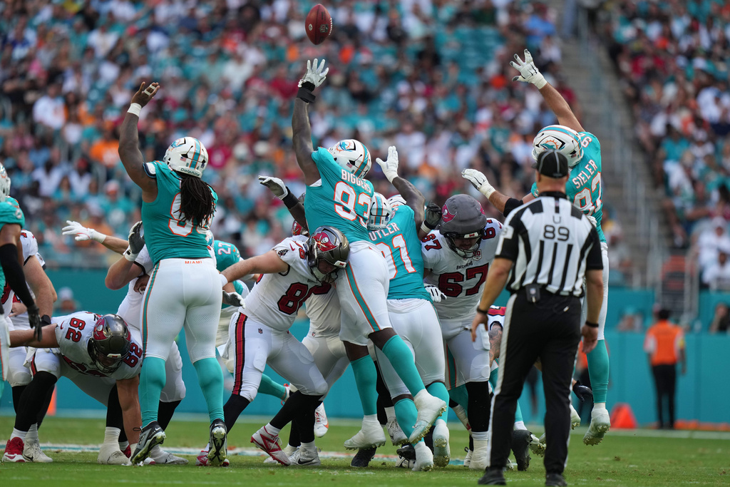 Miami Dolphins defensive tackle Zeek Biggers (93) blocks a field goal-attempt by the Tampa Bay Buccaneers during the first half of an NFL football game Sunday, Dec. 28, 2025, in Miami Gardens, Fla. (AP Photo/Lynne Sladky)