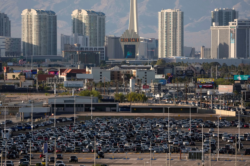 FILE - Cars fill a lot at Harry Reid International Airport near the Las Vegas Strip, April 9, 2025, in Las Vegas. (AP Photo/John Locher, File)