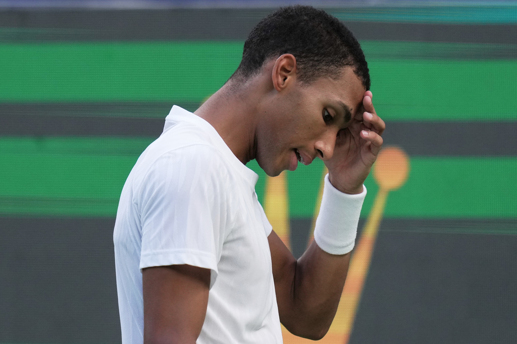 Felix Auger-Aliassime of Canada reacts after losing a point to Arthur Rinderknech of France during their men's singles quarterfinal match of the Shanghai Masters tennis tournament at Qizhong Forest Sports City Tennis Center, in Shanghai, China, Friday, Oct. 10, 2025. (AP Photo/Andy Wong)