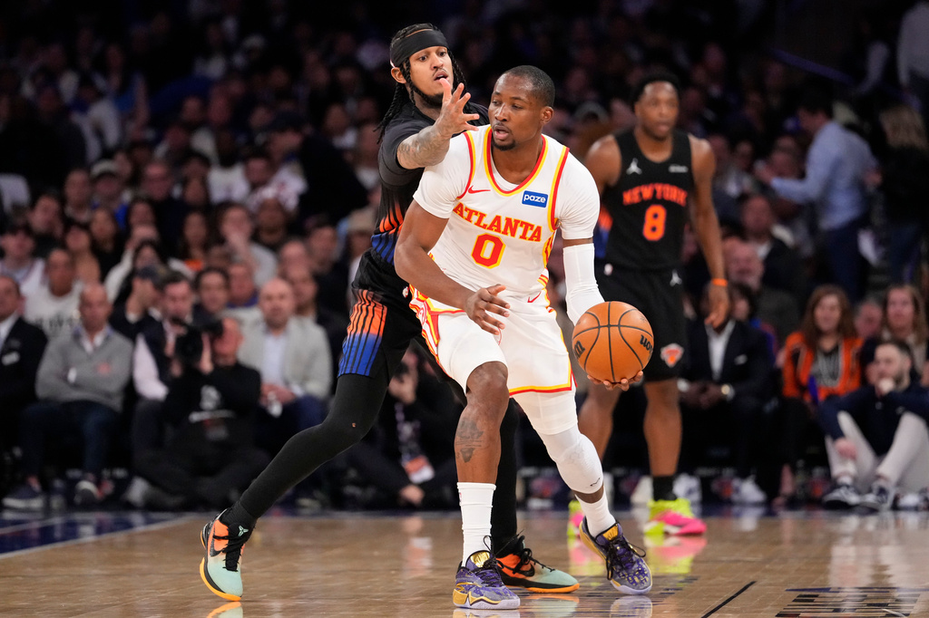 Atlanta Hawks forward Jonathan Kuminga (0) attempts to drive past New York Knicks guard Jordan Clarkson (00) during the first half in Game 2 of a first-round NBA playoffs basketball series, Monday, April 20, 2026, in New York. (AP Photo/Yuki Iwamura)