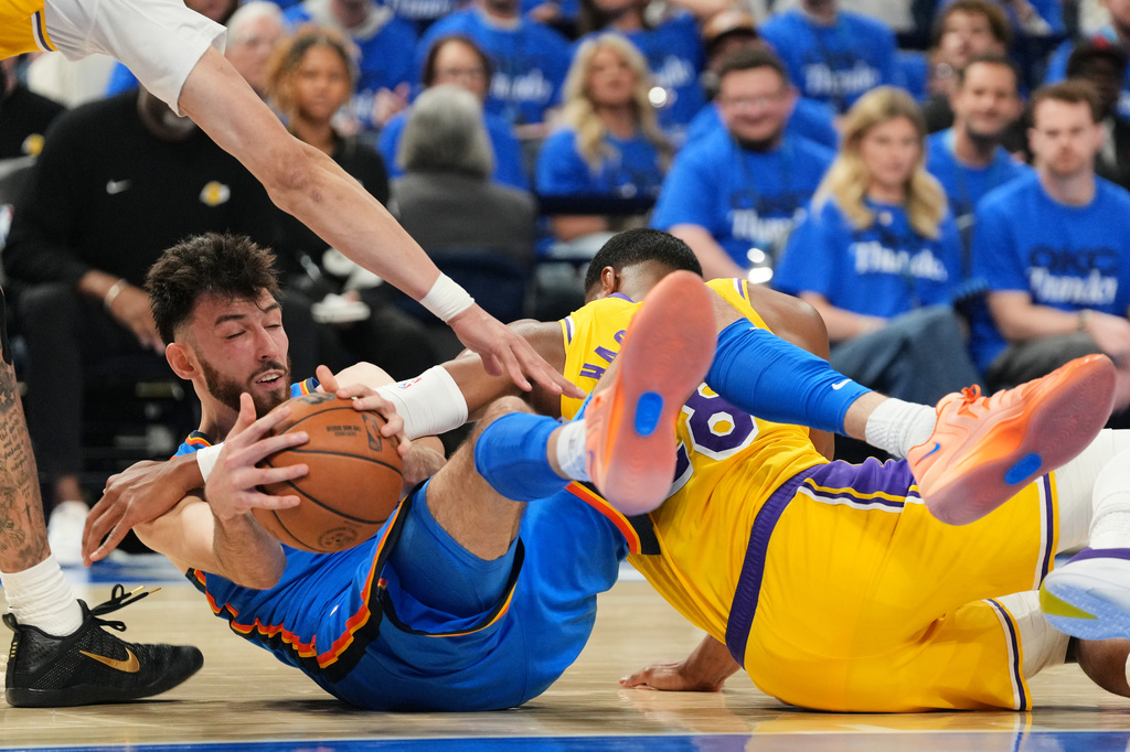 Oklahoma City Thunder's Chet Holmgren, left, competes for a loose ball against Los Angeles Lakers' Jaxson Hayes, left, and Rui Hachimura, right, in the second half of Game 1 in a second-round NBA basketball playoffs series Tuesday, May 5, 2026 in Oklahoma City. (AP Photo/Kyle Phillips)