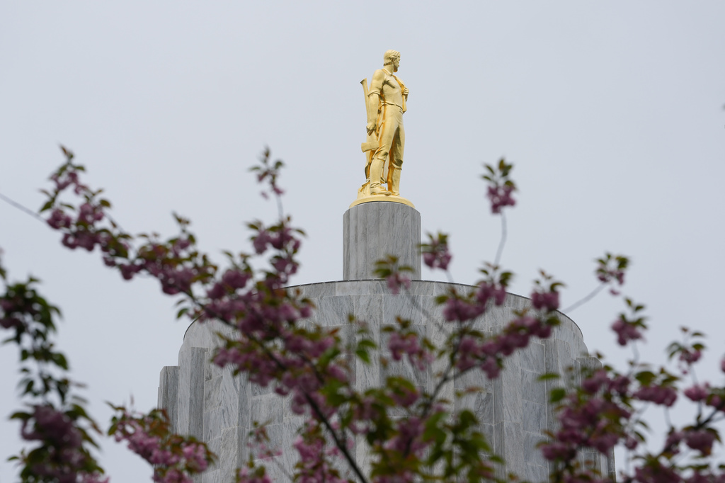 FILE - The Oregon Pioneer statue is seen on top of the Oregon State Capitol building, April 14, 2026, in Salem, Ore. (AP Photo/Jenny Kane, File)