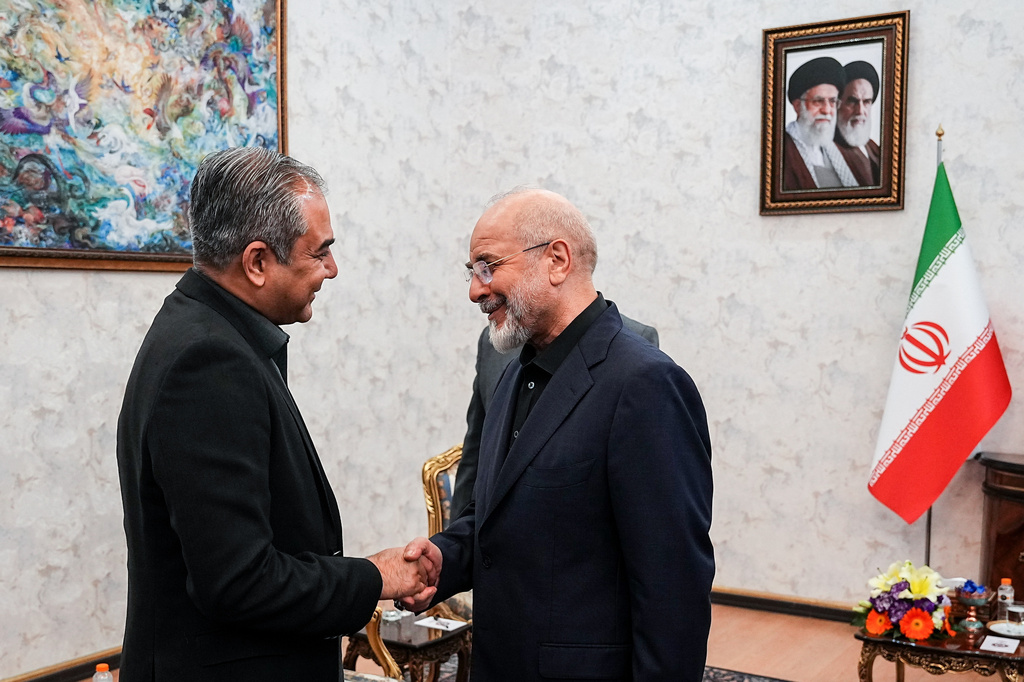 Iran's Parliament Speaker Mohammad Bagher Qalibaf, right, shakes hands with Pakistan's Interior Minister Mohsin Naqvi during their meeting in Tehran, Iran, Sunday, May 17, 2026. (Hamed Malekpour/ICANA via AP)