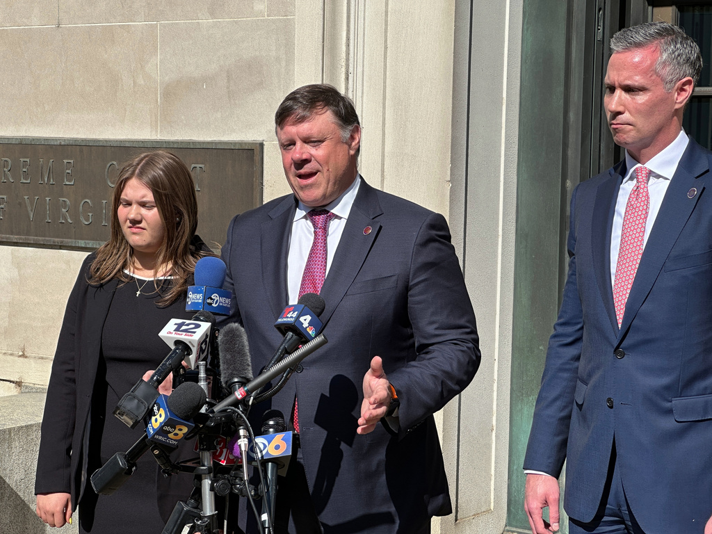State Senate Minority Leader Ryan McDougle, center, speaks with the media following a hearing on new congressional maps before the state Supreme Court in Richmond, Va., on Monday, April 27, 2026. (AP Photo/Allen G. Breed)