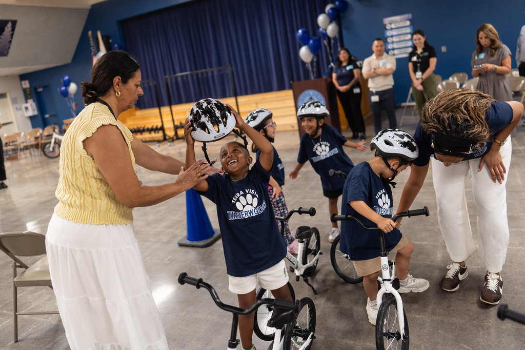 Kindergartner Carson Hagens, center, smiles as he removes his helmet after riding a bike during a learn-to-ride program at Terra Vista Elementary School in Rancho Cucamonga, Calif., Wednesday, Sept. 2, 2026. (AP Photo/Jae C. Hong)