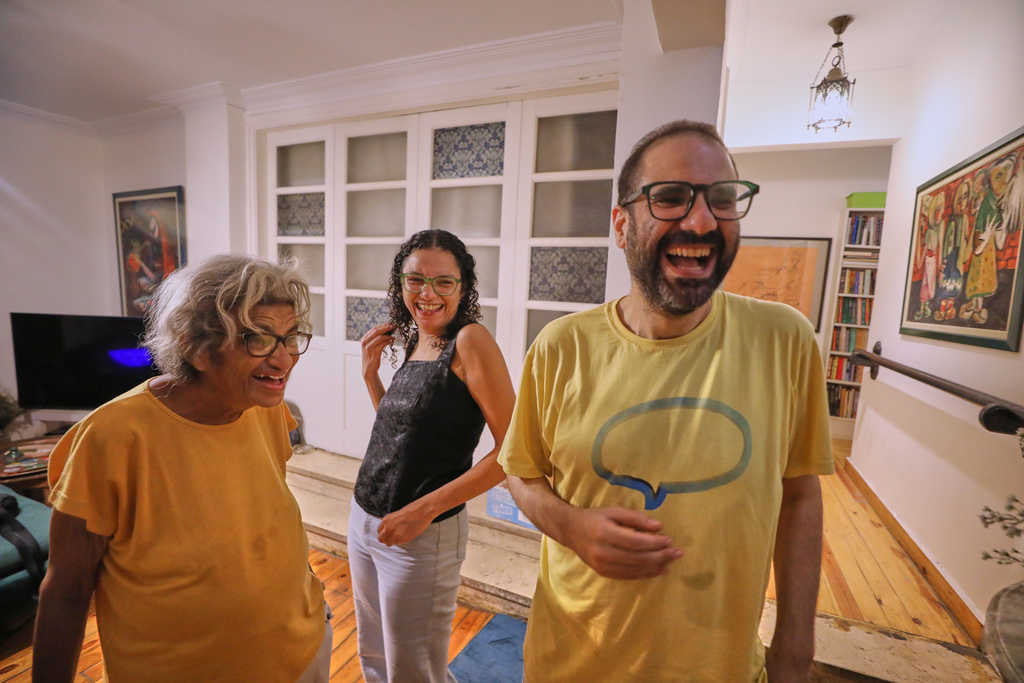 Pro-democracy activist Alaa Abd el-Fattah, who was in prison for almost all of the past 12 years, his mother Laila Soueif, and his sister, Sanaa Seif, smile as they receive guests at his home after a presidential pardon in Cairo, Tuesday, Sept. 23, 2025. (AP Photo/Khaled Elfiqi)