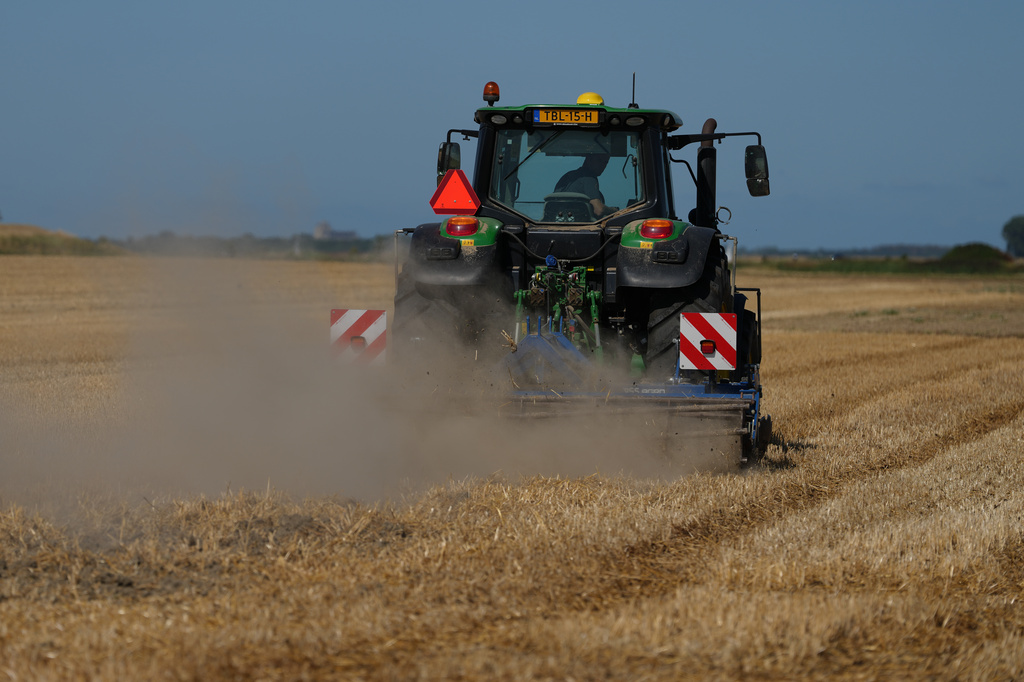 Farmer Maarten Janse drives his tractor on a drought stricken wheat field in Wolphaartsdijk, Netherlands, Tuesday, Aug. 11, 2026. (AP Photo/Virginia Mayo)