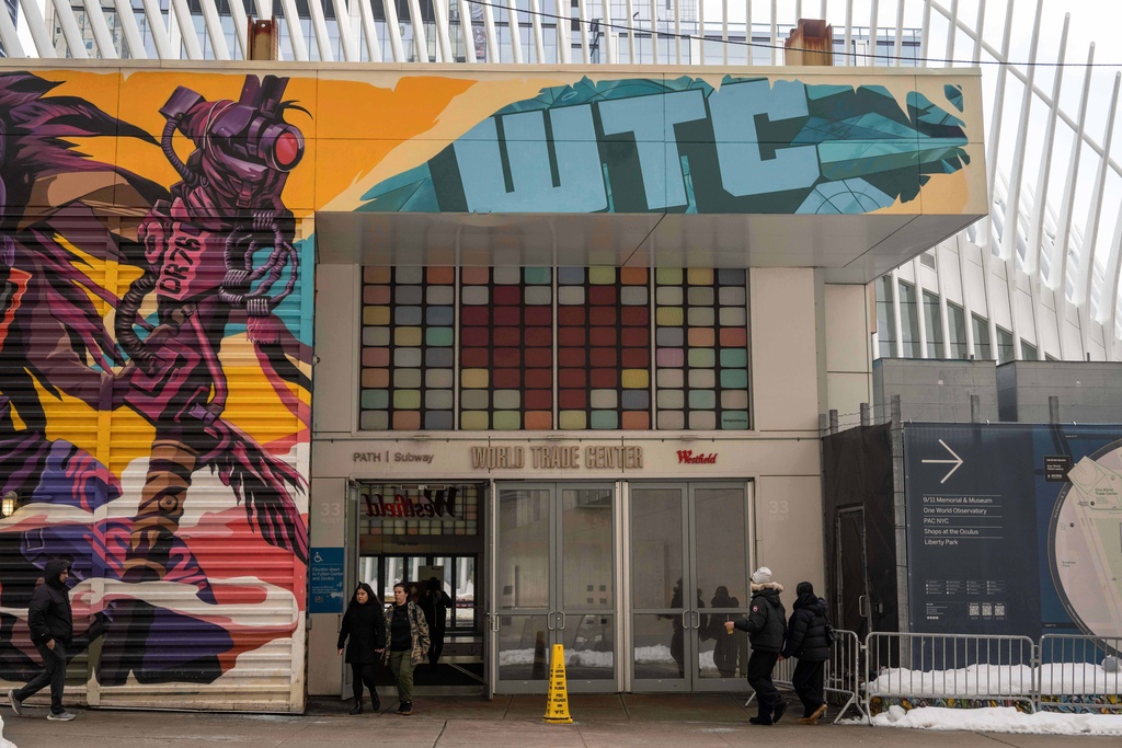 People walk past 2 World Trade Center where American Express will build new global headquarters, Wednesday, Feb. 25, 2026, in New York. (AP Photo/Yuki Iwamura)
