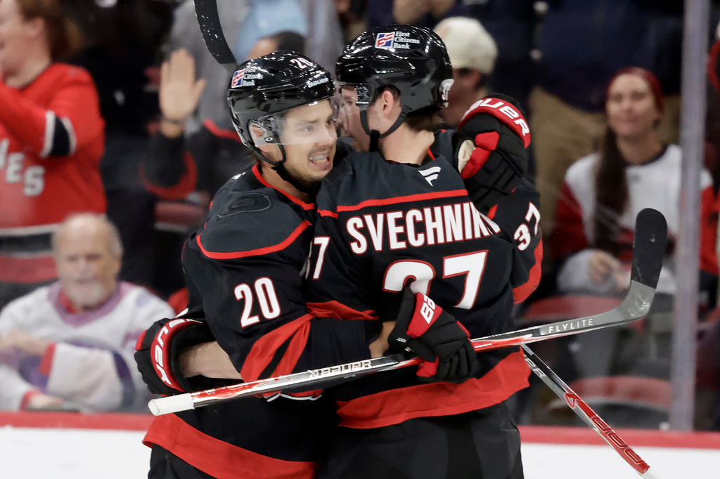 Carolina Hurricanes right wing Andrei Svechnikov (37) celebrates his goal with center Sebastian Aho (20) after he scored against the Vegas Golden Knights during the first period of an NHL hockey game Tuesday, Oct. 28, 2025, in Raleigh, N.C. (AP Photo/Chris Seward)