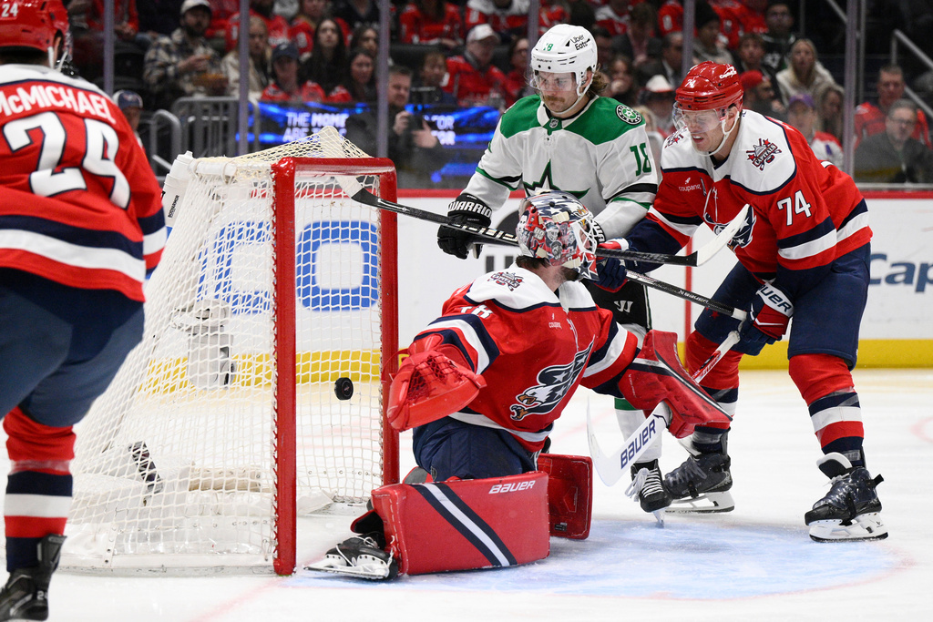 Dallas Stars center Sam Steel (18) scores a goal past Washington Capitals goaltender Logan Thompson (48) and defenseman John Carlson (74) during the second period of an NHL hockey game, Wednesday, Jan. 7, 2026, in Washington. (AP Photo/Nick Wass)