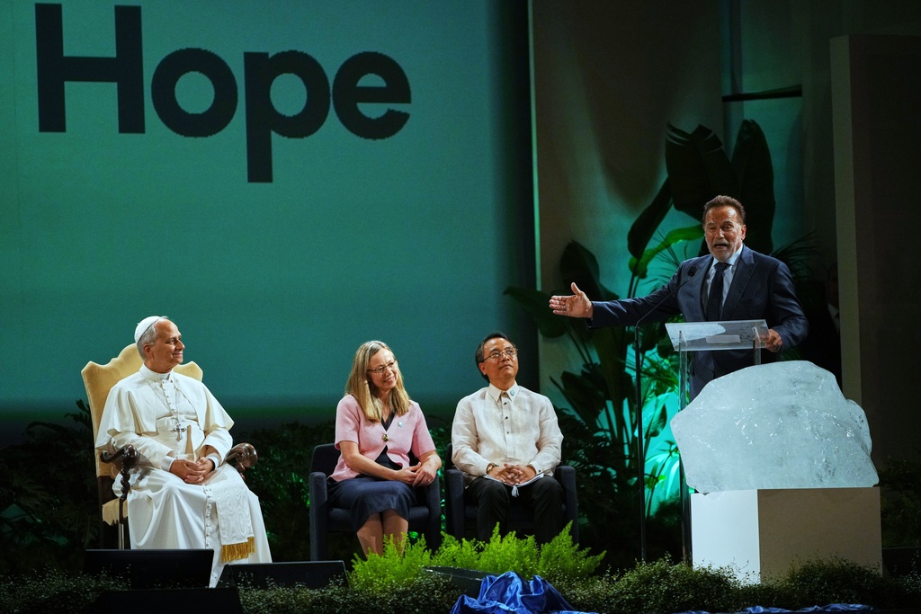 Arnold Schwarzenegger, right, delivers his speech at the International conference "Raising Hope for Climate Justice" attended by Pope Leo XIV, in Castel Gandolfo, Italy, Wednesday, Oct. 1, 2025. (AP Photo/Alessandra Tarantino)