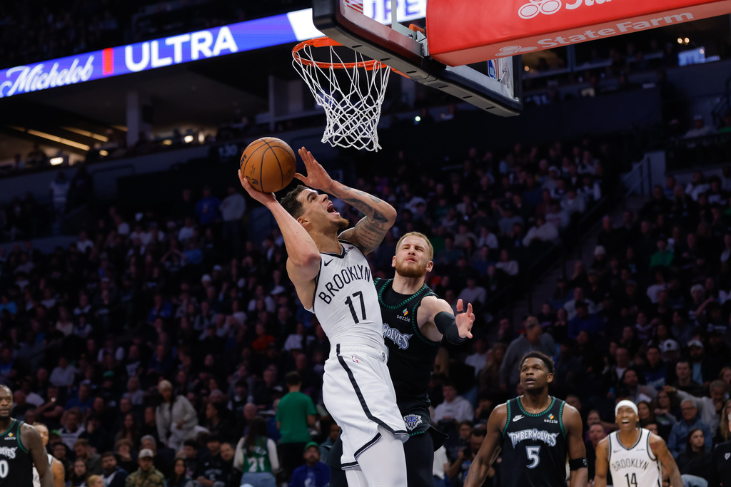 Brooklyn Nets forward Michael Porter Jr. (17) goes up to shoot while Minnesota Timberwolves guard Donte Divincenzo, center right, defends during the second half of an NBA basketball game, Saturday, Dec. 27, 2025, in Minneapolis. (AP Photo/Bailey Hillesheim)