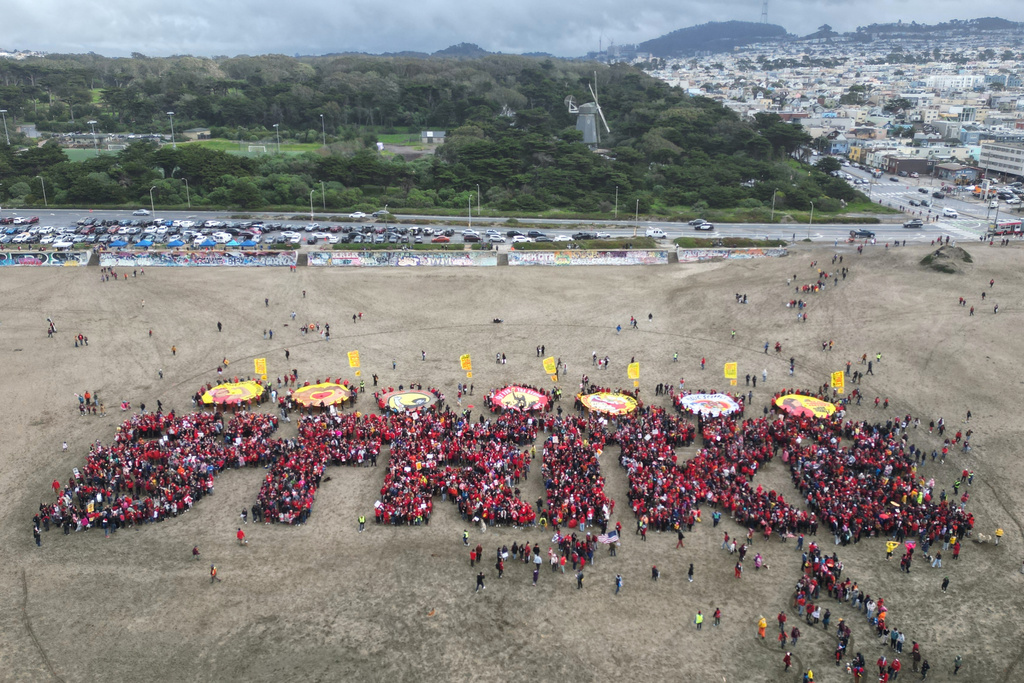 Hundreds of San Francisco teachers form a human banner spelling "STRIKE" on Ocean Beach on the third day of a district-wide strike over wages, benefits and other issues. (AP Photo/Terry Chea)