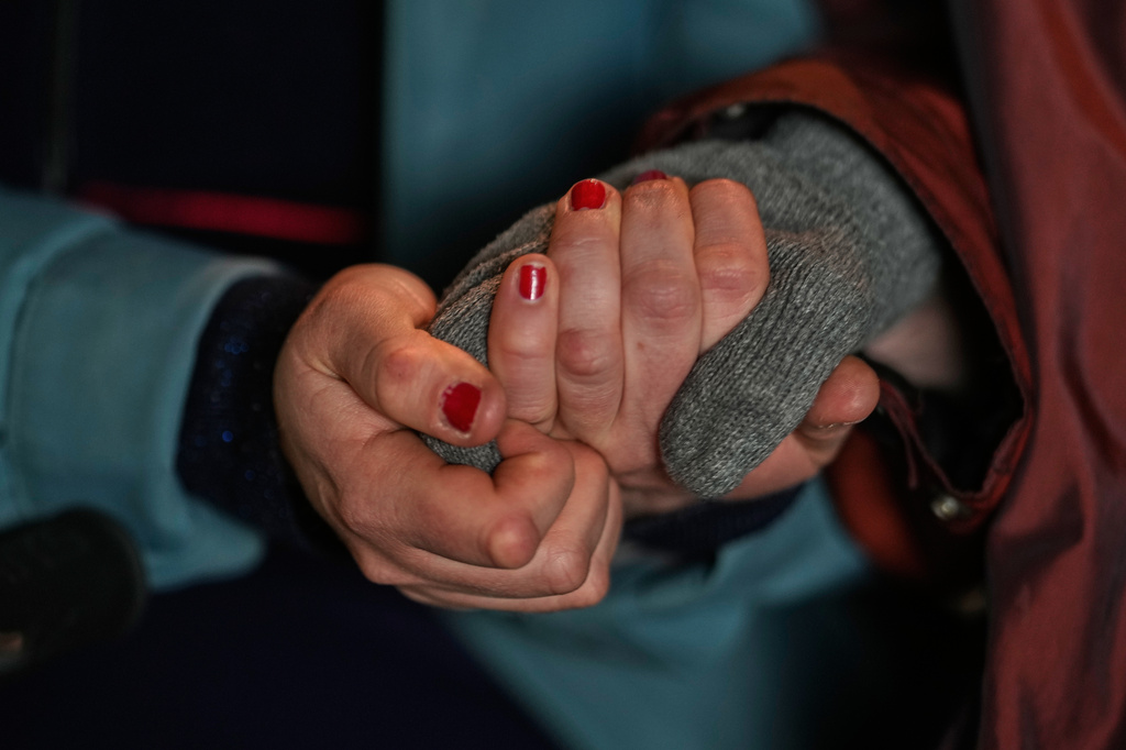 Project coordinator Christine Gruschka holds the hand of Monika Jansen 85, during a guided tour for people with dementia organized by Malteser Deutschland, part of the international Catholic aid organization Malteser Order of Malta, at the Zoo in Berlin, Germany, Thursday, March 26, 2026. (AP Photo/Markus Schreiber)