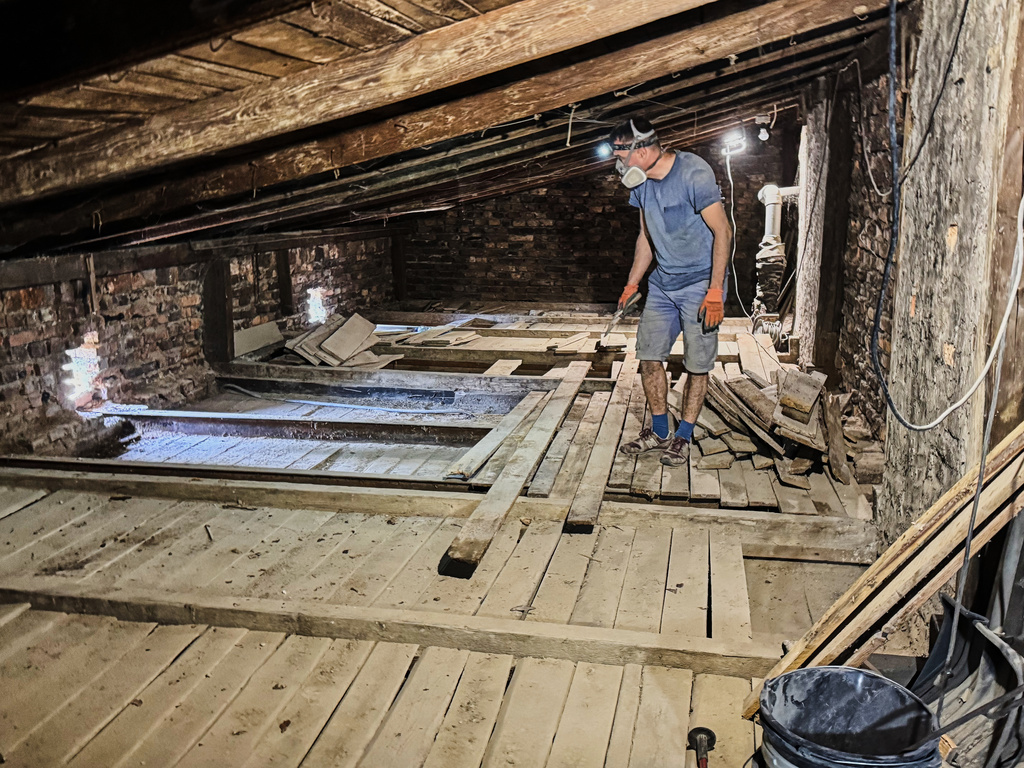 Wojciech Mazan, museologist and art historian, inspecting the attic of the "Będzin Ghetto Fighters Memorial" house in Bedzin, Poland, on May 29, 2026. (AP Photo/Rafal Niedzielski)