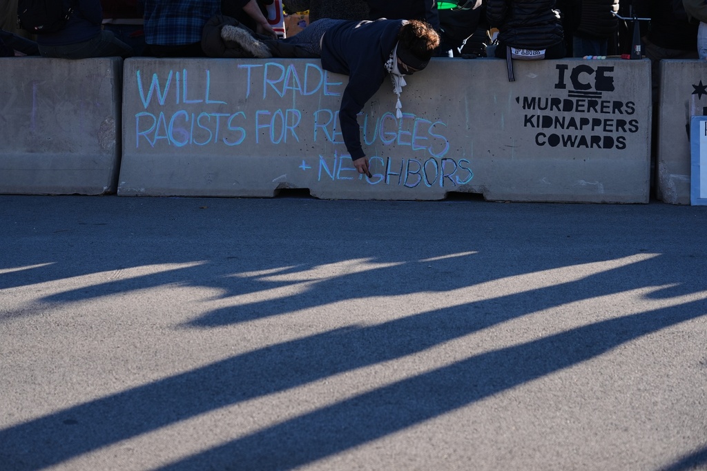 Protesters gather outside an ICE processing facility in Broadview, Ill. a suburb of Chicago, Friday, Oct. 24, 2025. (AP Photo/Nam Y. Huh)