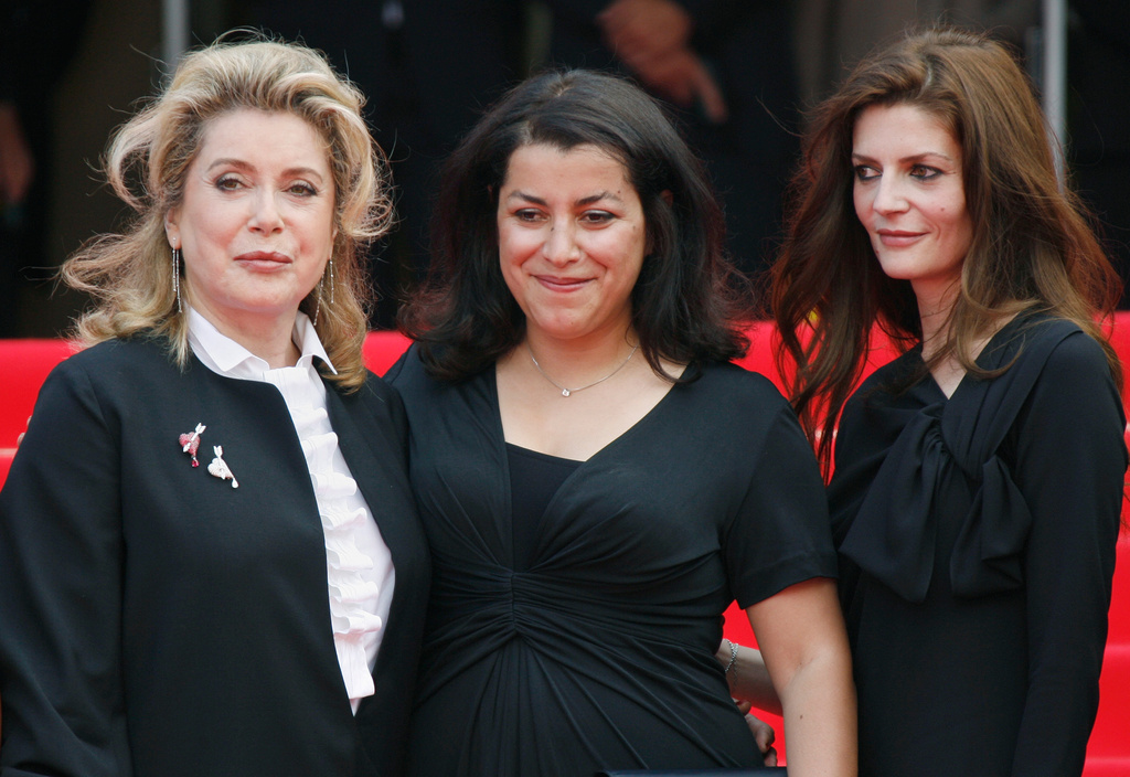 FILE - Iranian born director Marjane Satrapi, center, French actress Catherine Deneuve, right, and Deneuve's daughter Chiara Mastroianni arrive for the screening of the film "Persepolis," at the 60th International film festival in Cannes, southern France, on Wednesday, May 23, 2007. (AP Photo/Andrew Medichini, File)