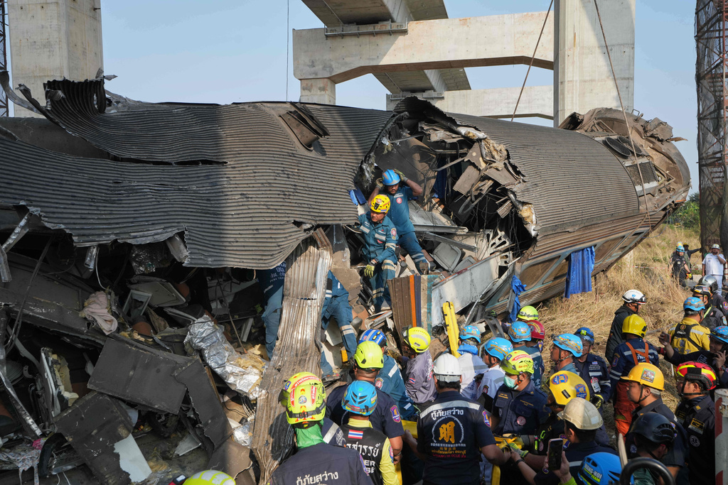 Rescuers work amidst the wreckage after a construction crane fell into a passenger train in Nakhon Ratchasima province, Thailand, Wednesday, Jan.14, 2026. (AP Photo/Sakchai Lalit))