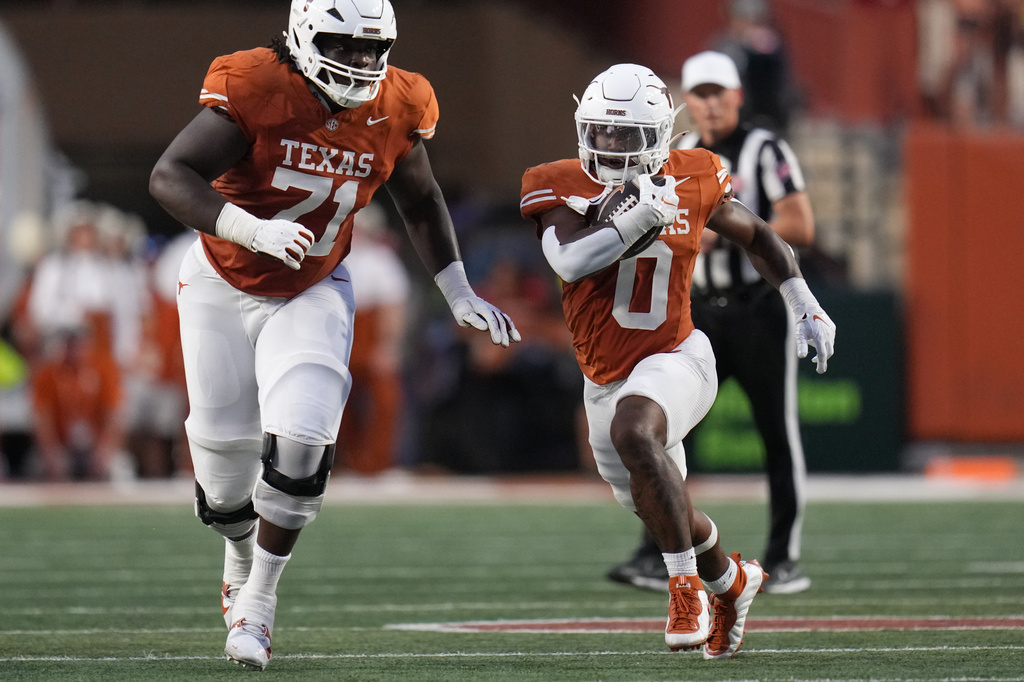 Texas running back Raleek Brown (0) runs against Ohio State during the first half of an NCAA college football game in Austin, Texas, Saturday, Sept. 12, 2026. (AP Photo/Eric Gay)