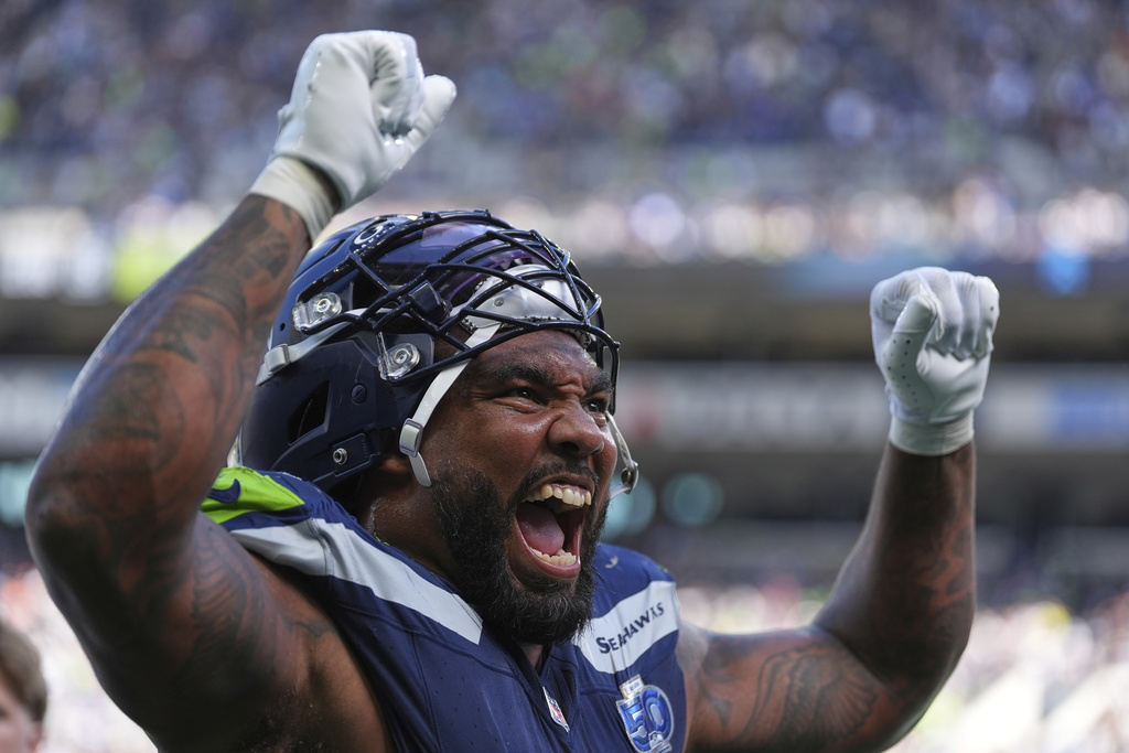 Seattle Seahawks defensive end Leonard Williams (99) celebrates as he walks to the locker room at the end of the first half of an NFL football game against the New Orleans Saints, Sunday, Sept. 21, 2025, in Seattle. (AP Photo/Lindsey Wasson)