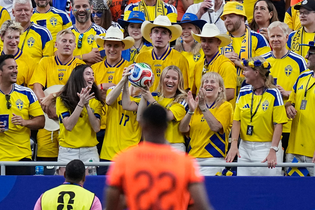 A Sweden fan catches a football that landed on the stands during the World Cup Group F soccer match between the Netherlands and Sweden in Houston, Saturday, June 20, 2026. (AP Photo/Ashley Landis)
