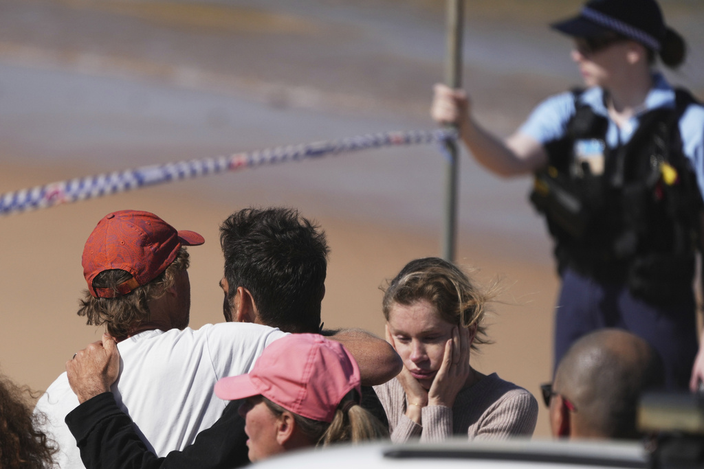 People react at the site of a fatal shark attack at Dee Why Beach in Sydney, Australia, Saturday, Sept. 6, 2025. (AP Photo/Mark Baker)