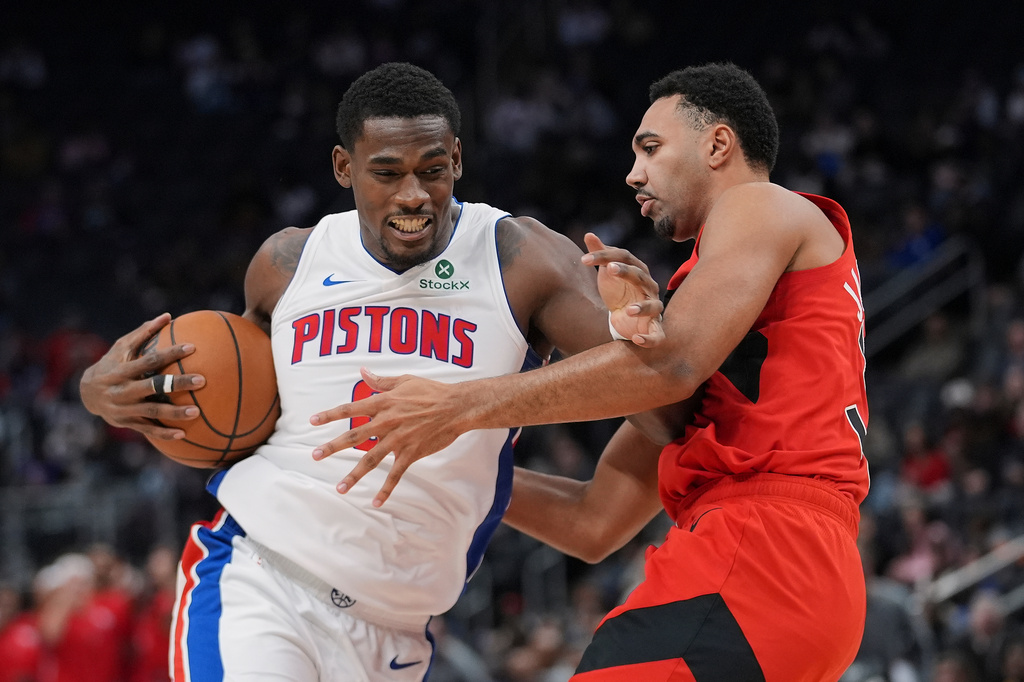 Detroit Pistons center Jalen Duren (0) drives on Toronto Raptors forward Trayce Jackson-Davis (32) in the first half of a preseason NBA basketball game in Detroit, Friday, Oct. 16, 2026. (AP Photo/Paul Sancya)