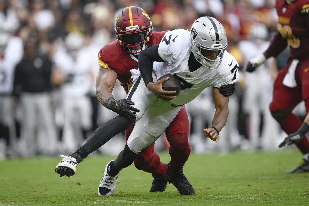 Washington Commanders linebacker Bobby Wagner (54) sacks Las Vegas Raiders quarterback Geno Smith (7) during the second half of NFL football game Sunday, Sept. 21, 2025, in Landover, Md. (AP Photo/Nick Wass)