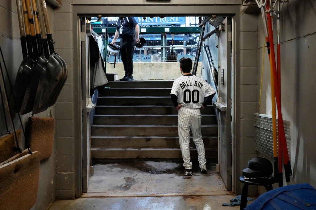 A Chicago White Sox ball boy looks to the field during a rain delay before a baseball game between the Atlanta Braves and the Chicago White Sox in Chicago, Thursday, June 11, 2026. (AP Photo/Nam Y. Huh)