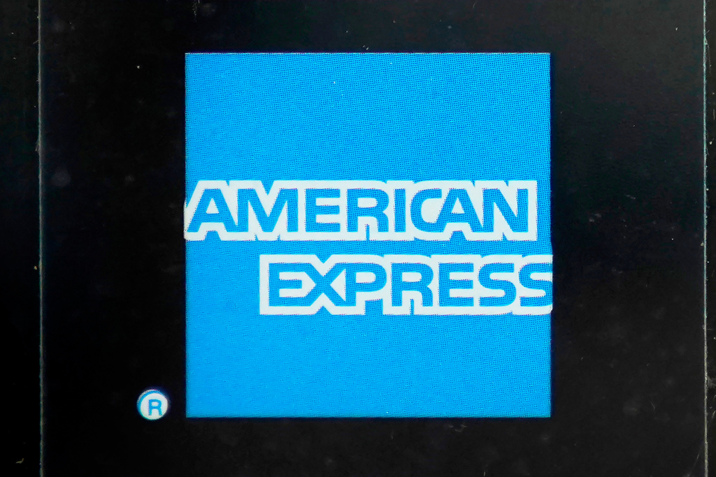 FILE - An American Express logo is attached to a door in Boston's Seaport District, Wednesday, July 21, 2021. (AP Photo/Steven Senne, File)