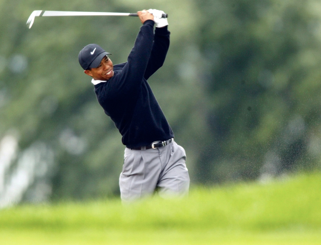 FILE - Tiger Woods hits his second shot on the 18th hole from a fairway bunker during completion of his second round of the PGA Championship at Hazeltine National Golf Club, in Chaska Minn., Saturday, Aug. 17, 2002. (AP Photo/Doug Mills)