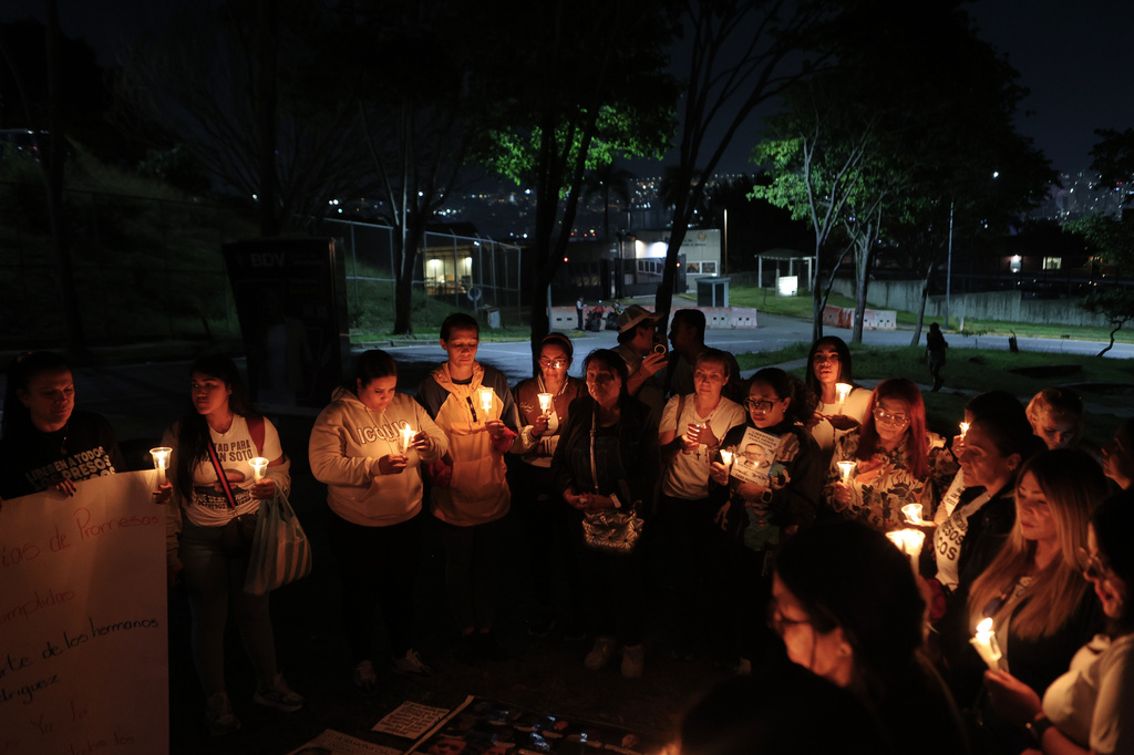 Relatives and activist of political prisoners seeking a meeting with Chargé d'Affaires John M. Barrett gather at a vigil near the U.S. Embassy in Caracas, Venezuela, Monday, June 8, 2026. (AP Photo/Pedro Mattey)