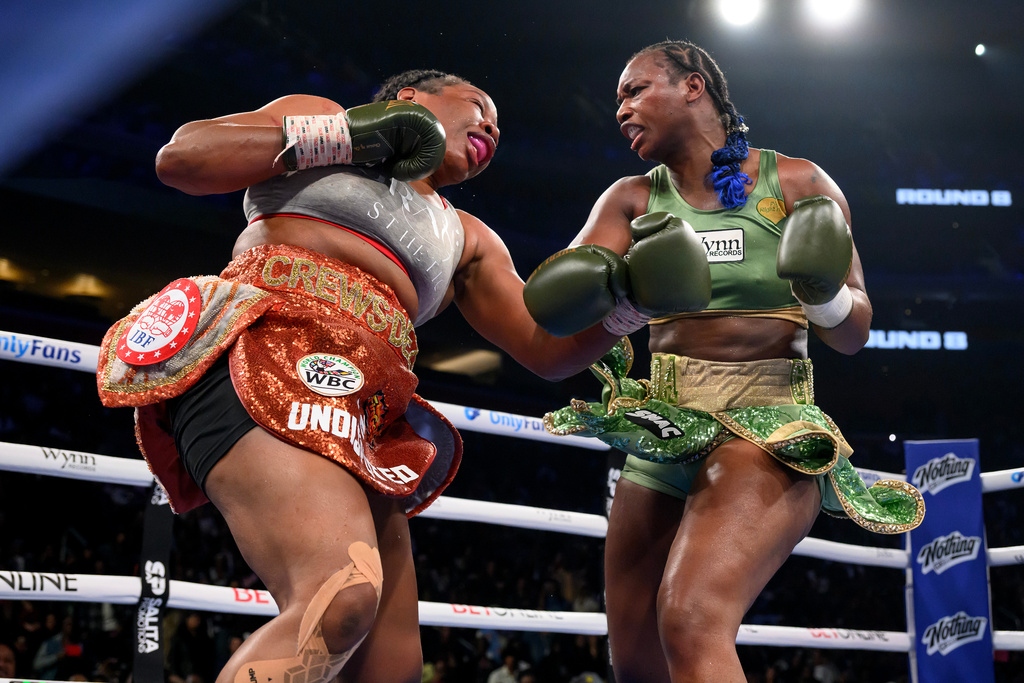 Claressa Shields, right, and Franchon Crews-Dezurn square off in the eighth round of their Undisputed Heavyweight World Championship boxing match, Sunday, Feb. 22, 2026, in Detroit. (AP Photo/Lon Horwedel)