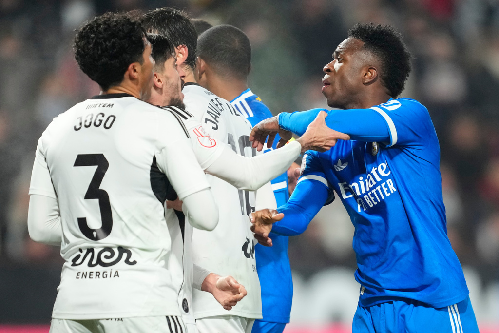 Real Madrid's Vinicius Junior argues with Albacete's players during the Copa del Rey round of 16 soccer match between Albacete and Real Madrid, in Albacete, Spain, Wednesday, Jan. 14, 2026. (AP Photo/Jose Breton)