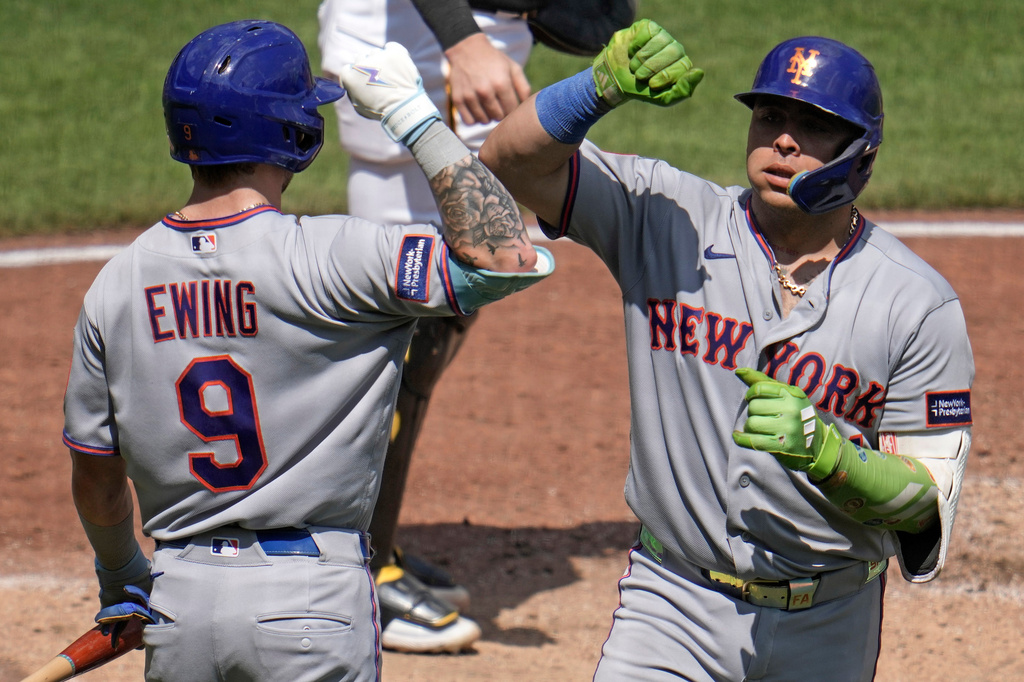 New York Mets' Francisco Alvarez, right, is greeted by A.J. Ewing (9) as he returns to the dugout after hitting a solo home run off Pittsburgh Pirates pitcher Kirby Yates during the fifth inning of a baseball game in Pittsburgh, Sunday, Aug. 9, 2026. (AP Photo/Gene J. Puskar)