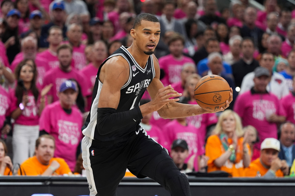 San Antonio Spurs forward Victor Wembanyama (1) drives against the New York Knicks during the first half of Game 1 of the NBA Finals basketball series, Wednesday, June 3, 2026, in San Antonio. (AP Photo/Eric Gay)