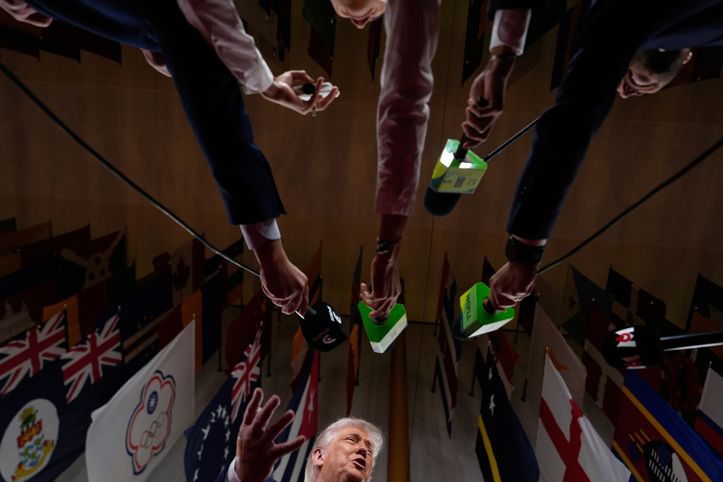 President Donald Trump speaks to reporters as he arrives to attend the draw for the 2026 soccer World Cup at the Kennedy Center in Washington, Friday, Dec. 5, 2025. (AP Photo/Julia Demaree Nikhinson)