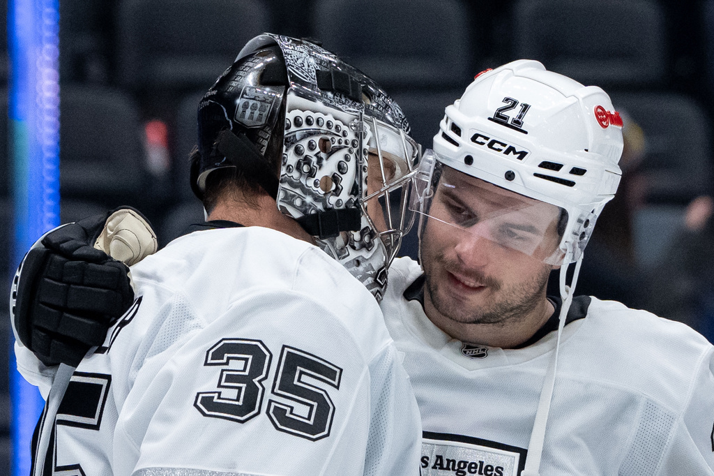 Los Angeles Kings goaltender Darcy Kuemper (35) celebrates with Los Angeles Kings' Scott Laughton (21) after defeating the Vancouver Canucks in an NHL hockey game in Vancouver, British Columbia, Thursday, March 26, 2026. (Ethan Cairns/The Canadian Press via AP)