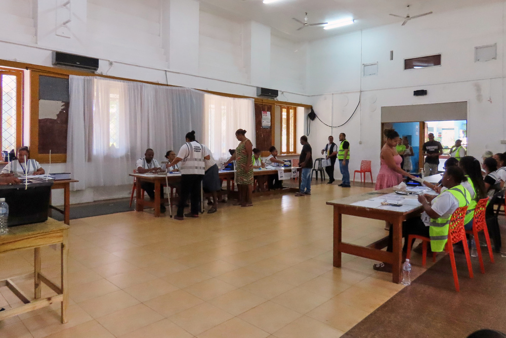 Electoral commission staff monitor as people cast their votes in a runoff presidential election at Mont Fleuri Secondary School, Mont Fleuri, Mahe, Seychelles, Saturday, Oct. 11, 2025. (AP Photo/Emilie Chetty)