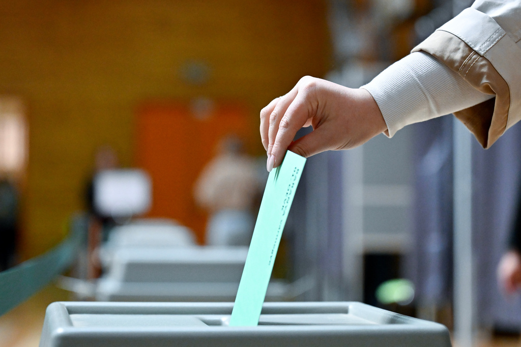 A woman casts her ballot at a polling station during the Hungarian parliamentary election in Budapest, Hungary, Sunday, April 12, 2026. (AP Photo/Denes Erdos)