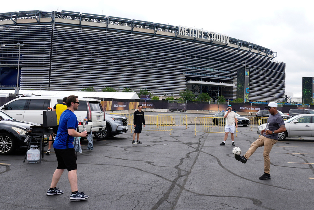 FILE - Fans play with a ball outside the Metlife Stadium prior to the Club World Cup final soccer match between Chelsea and PSG in East Rutherford, N.J., Sunday, July 13, 2025. (AP Photo/Pamela Smith, File)