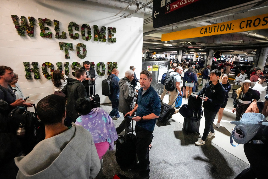 Airline passengers wait in long lines outside the terminal to get through the TSA security screening at William P. Hobby Airport in Houston, Sunday, March 8, 2026. (Brett Coomer/Houston Chronicle via AP)