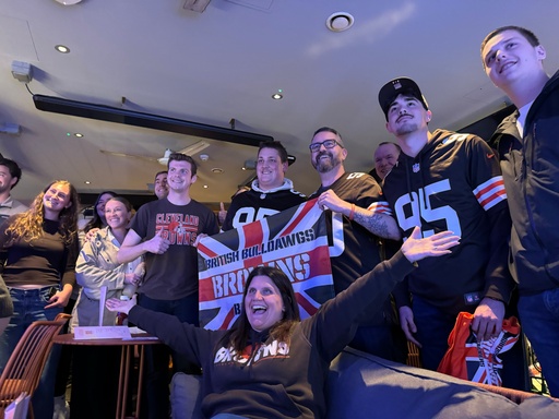 Kelly Burgess Taylor, seated, president of the British Bulldawgs Browns Backers, celebrates a Cleveland Browns victory with other club members at the Hippodrome Casino in London on Sept. 21, 2025. (AP Photo/Kenneth Maguire) Kelly Burgess Taylor, seated, president of the British Bulldawgs Browns Backers, celebrates a Cleveland Browns victory with other club members at the Hippodrome Casino in London on Sept. 21, 2025. (AP Photo/Kenneth Maguire)