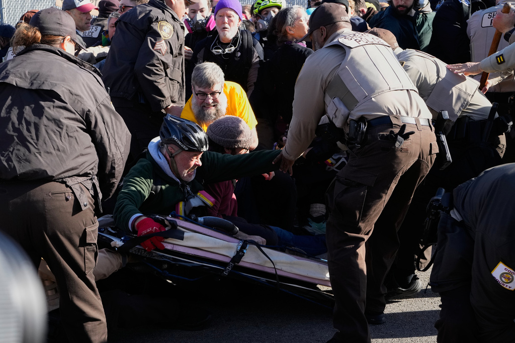 Illinois State Police and Cook County Sheriff Police guard as protesters gather outside an ICE processing facility in the Chicago suburb of Broadview, Ill., Friday, Nov. 14, 2025. (AP Photo/Nam Y. Huh)