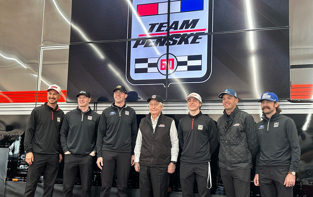 Team Penske pose for a photo as they celebrate its 60th season in motorsports on Friday, March 6, 2026 at Phoenix Raceway in Avondale, Arizona. L-R, Joey Logano, Josef Newgarden, Austin Cindric, Roger Penske, David Malukas, Scott McLauglin and Ryan Blaney. (AP Photo Jenna Fryer)