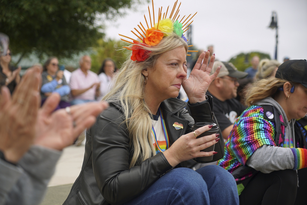 A woman wipes away tears as she listens to a speaker during Pride Fest in Wake Forest, N.C., on Saturday, Oct. 11, 2025. (AP Photo/Allen G. Breed)